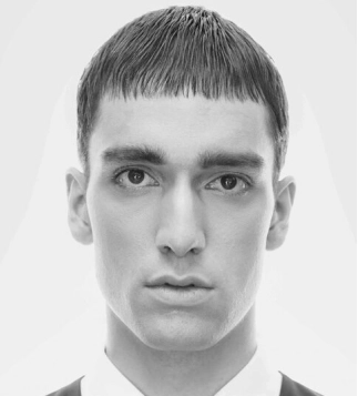 Contemporary men’s haircut with short fringe styled by Eddine Belaid – Precision grooming and modern hair design in Switzerland